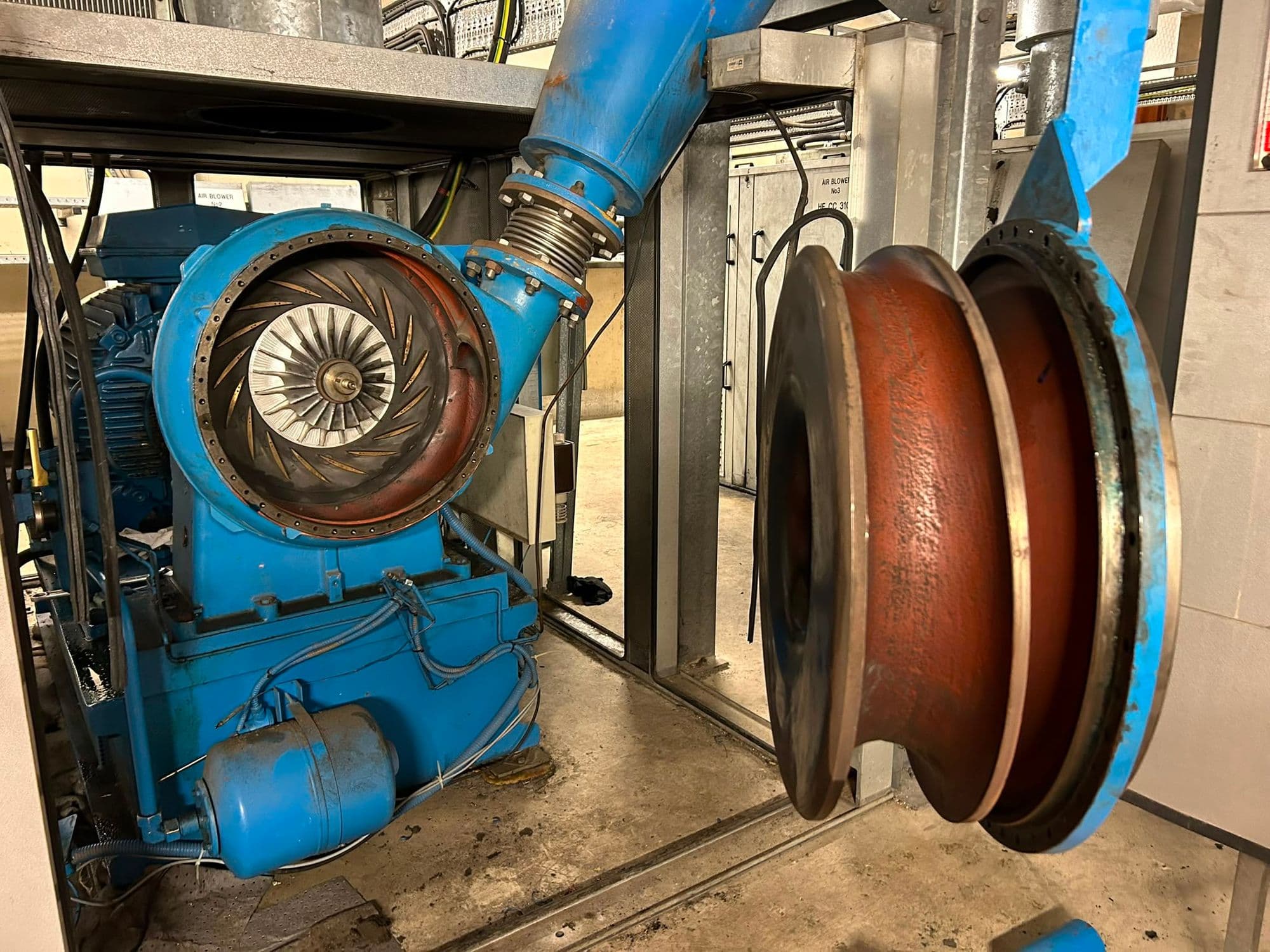 Turbo blower opened in a plant room with its impeller exposed