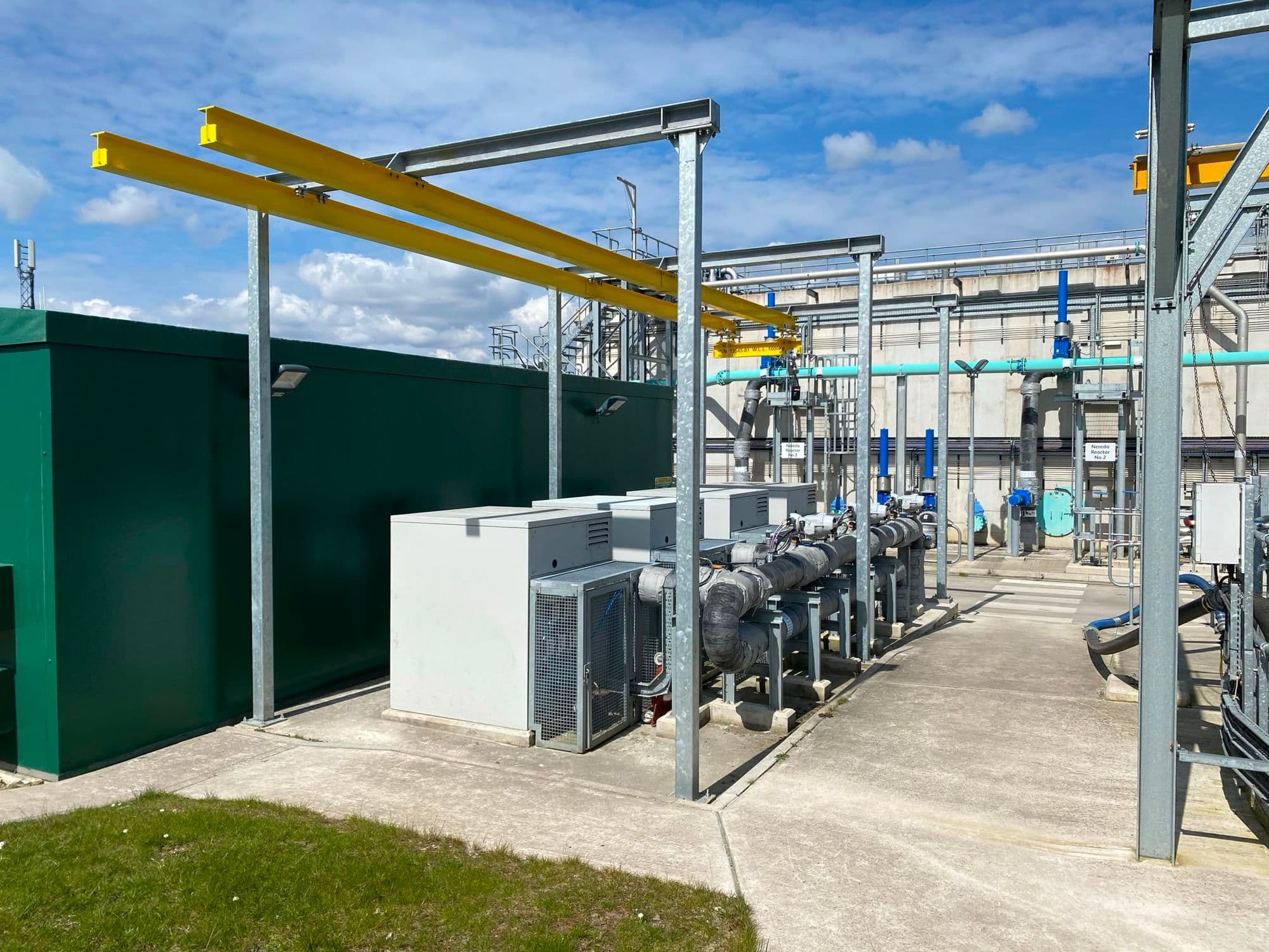 Outdoor blower compound with grey acoustic canopies and lagged pipework