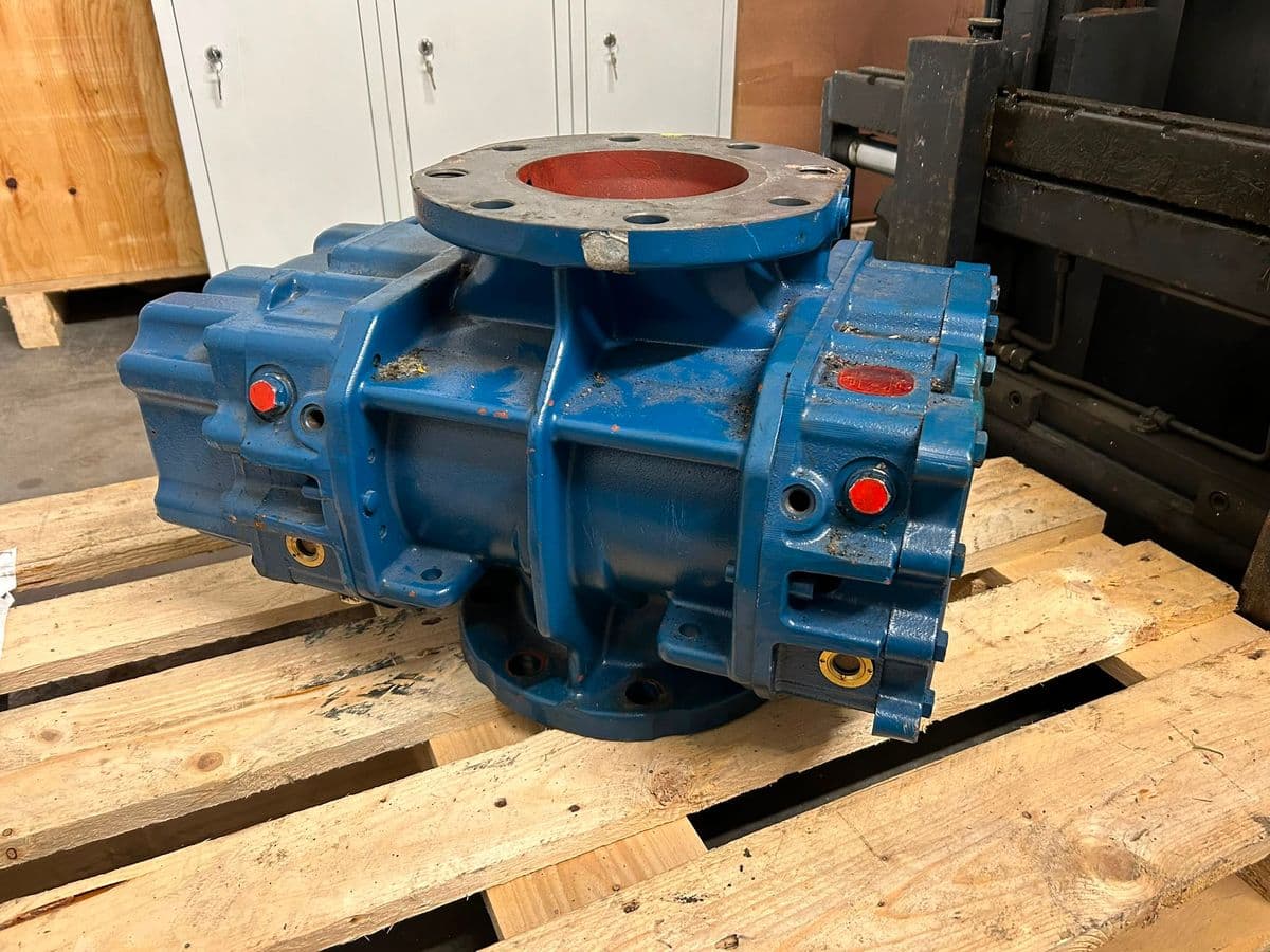 Blue bare-shaft lobe blower on a pallet with its ports capped