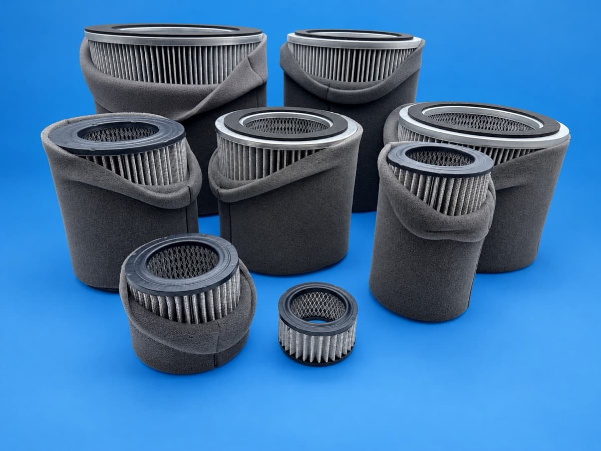 Range of new inlet filter elements with foam pre-filters grouped by size on the workshop floor