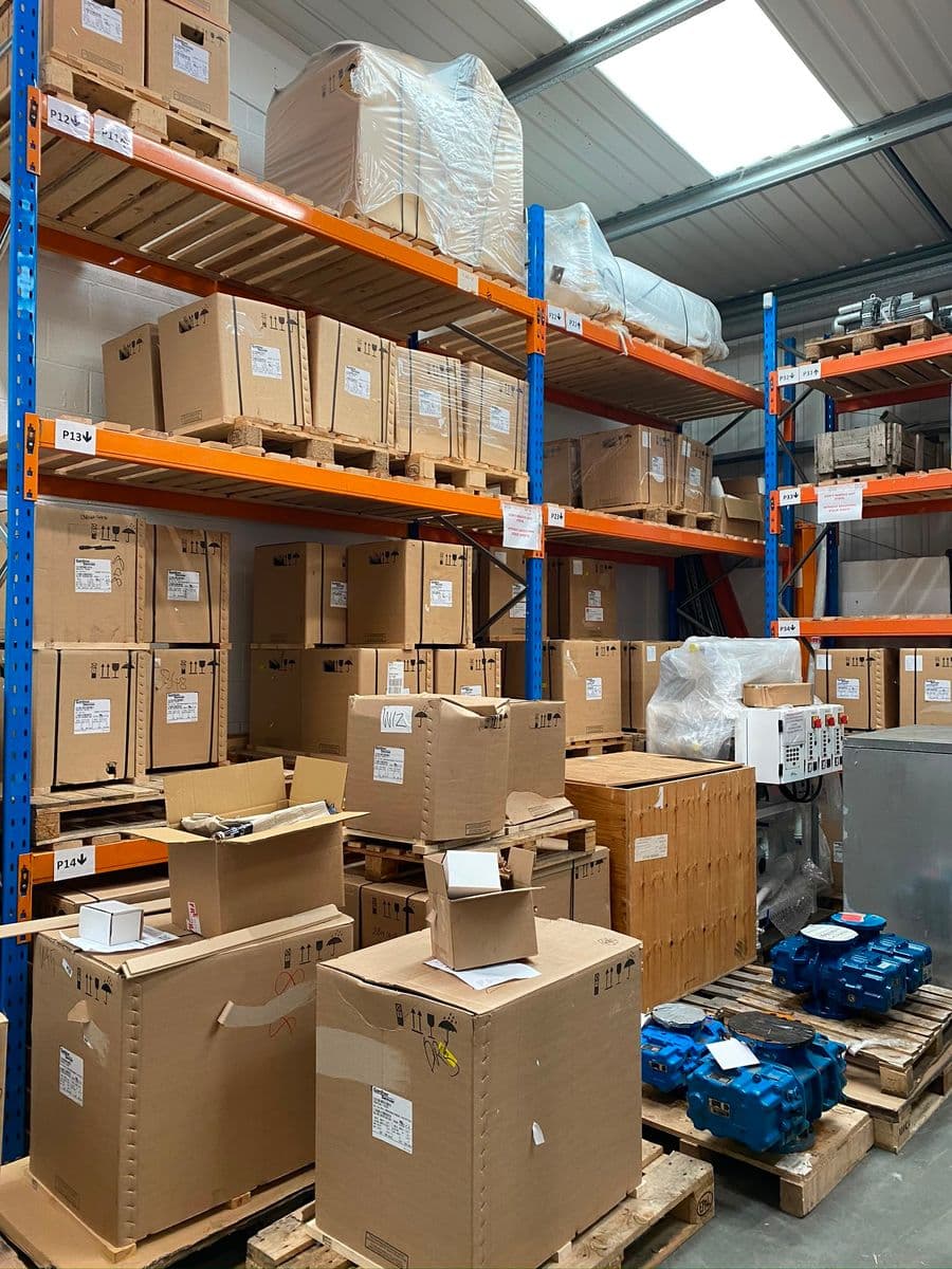 Stores racking holding boxed blowers and bare spare blocks
