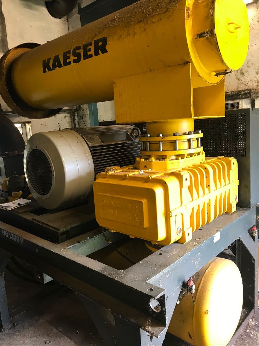 Yellow Kaeser Omega rotary lobe blower with a large inlet silencer