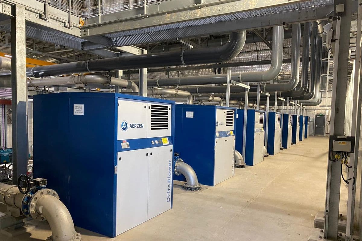 Long row of Aerzen Delta blower packages in a bright blower hall