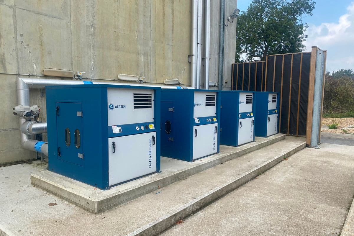 Four Aerzen Delta blower packages on an outdoor plinth behind a timber acoustic screen