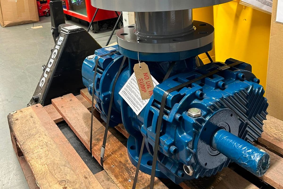 Refurbished Robuschi lobe blower repainted blue with a new silencer and service tag on a pallet