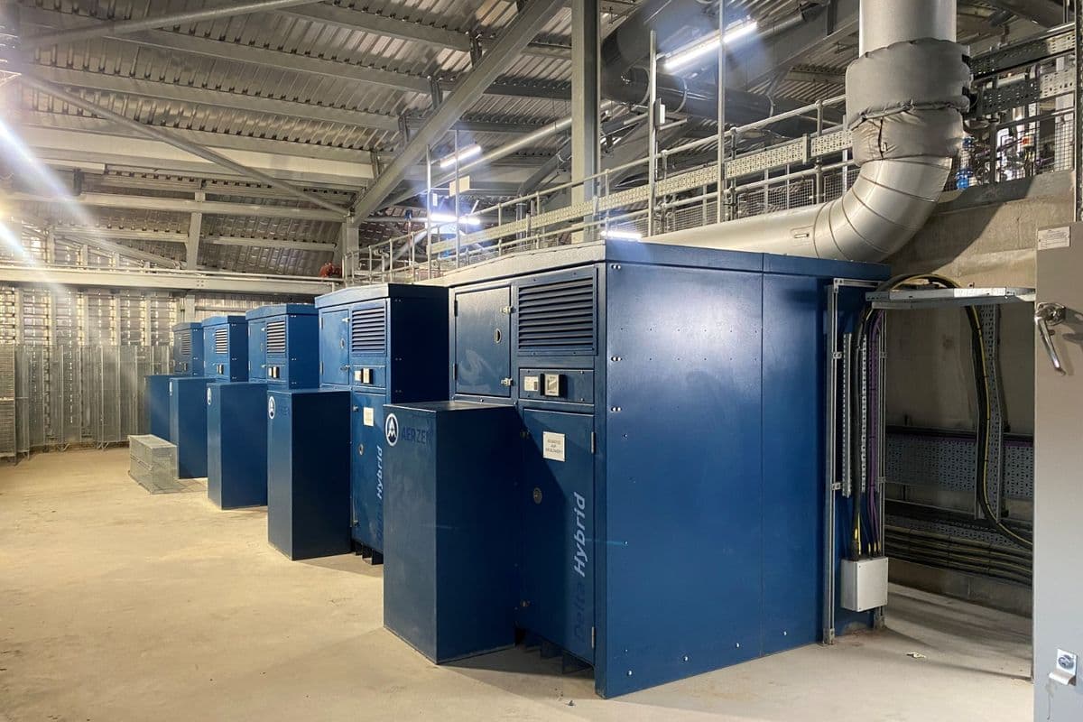 Row of navy Aerzen Delta Hybrid blower packages in a modern plant room